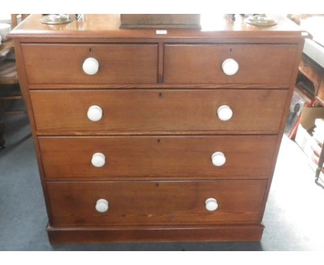 A Victorian pitch pine chest of drawers with white ceramic knobs. 45" wide  