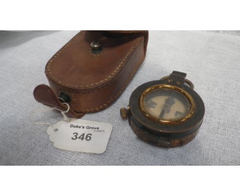 A military compass in a leather pouch 