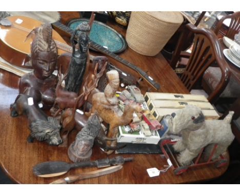 A vintage plush dog on wheels with articulated legs, a collection of 'Days Gone' model vehicles, a quantity of carved ethnic 