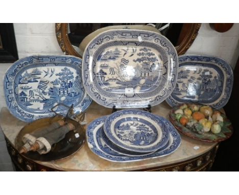 A Portuguese Majolica study of fruit on a dish, a collection of 'willow pattern' dinner ware, a similar transfer decorated pl
