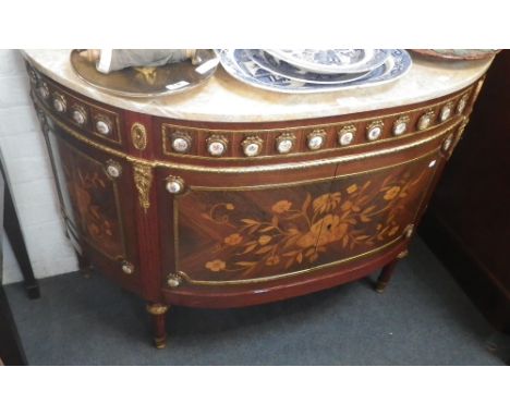 A bowfronted French side cabinet with marquetry decoration and applied gilt and ceramic decoration with pale marble top. 43" 