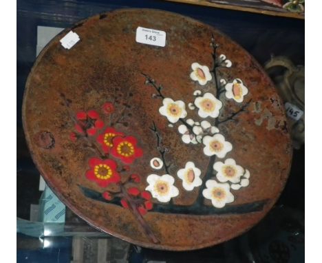 An enamel decorated copper charger, decorated with floral sprigs  