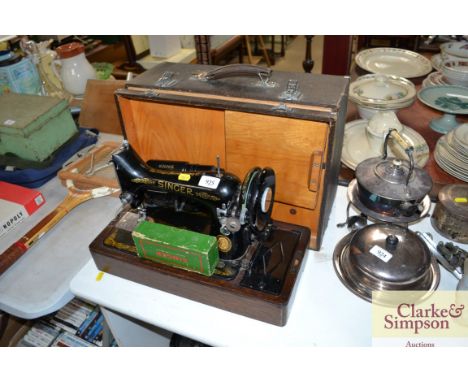An electric Singer sewing machine, sold as collector's item, in fitted case