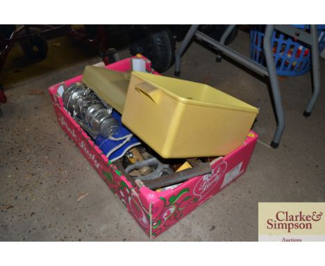 A box containing various tools, hurricane lamp etc.