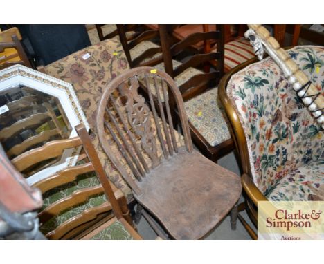 A flora upholstered nursing chair together with an elm seated stick and wheelback chair