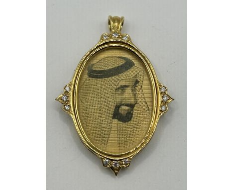 An 18ct gold oval pendant, engraved a portrait, set with white stones, 21.6 g (all in)