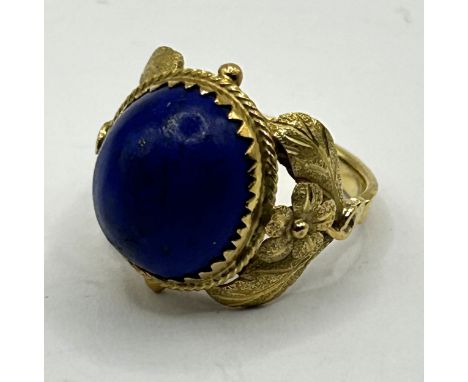 A late 19th/early 20th century yellow metal and cabochon cut lapis lazuli ring, ring size M