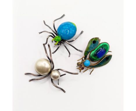 A silver and enamel spider brooch, a similar fly brooch, and a faux pearl and silver spider brooch (3)
