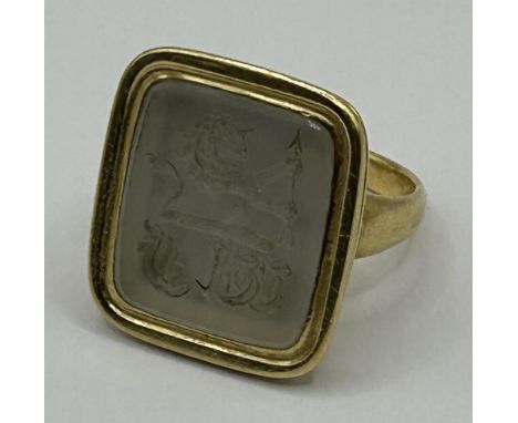 An intaglio ring, decorated a crest and initialsRing size I, testing as 9ct, 10.5 g all in