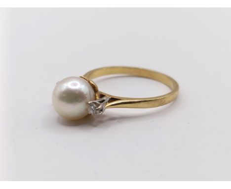 An 18ct gold pearl and diamond ring, ring size N