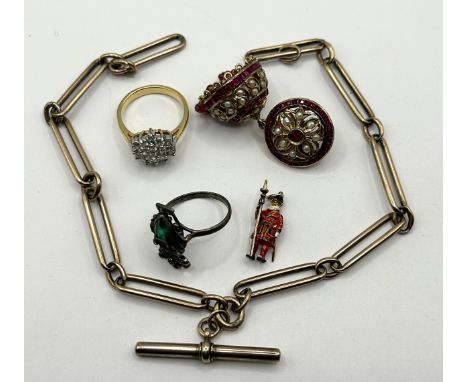 A watch chain, an enamel Beefeater charm, and other jewellery