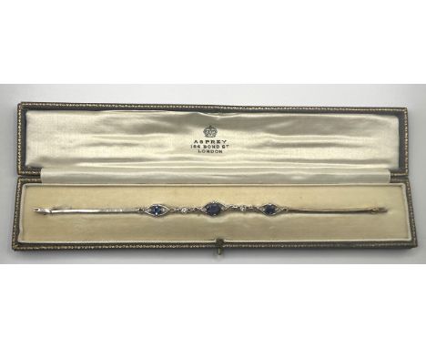 A yellow coloured metal, diamond and sapphire bracelet, apparently unmarked, in an Asprey fitted leather box18 cm long overal