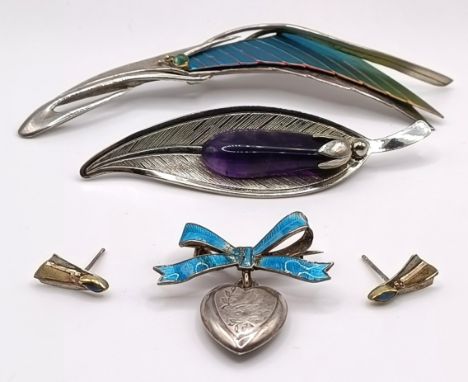 A 20th century silver and enamel brooch, another, a pair of earrings, and a blue enamel and silver brooch (4)