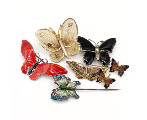 A silver and enamel butterfly brooch, 45 mm wide, three other butterfly brooches, a butterfly pin, and a pair of ear studs (7