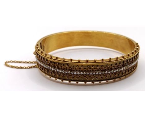 An Italian&nbsp;15ct gold and seed pearl&nbsp;Castellani bangle, 21.8 g all in