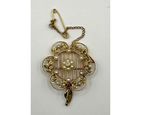 A 15ct gold, diamond and seed pearl openwork flowerhead brooch, approx 3 cm diameter, with a safety chain