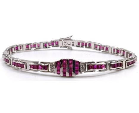 An Art Deco style 14ct gold and baguette cut bracelet
