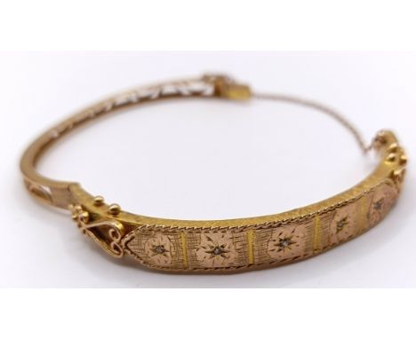 A yellow metal hinged bangle, 13 g testing as 18ct