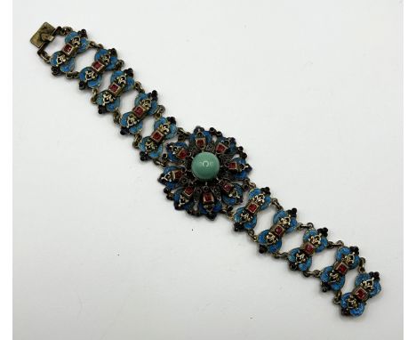 A silver gilt  turquoise enamel and red paste bracelet, turquoise loosevarious losses to enamel