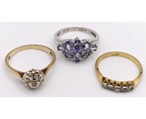 An 18ct gold and diamond five stone ring, ring size L, a 9ct gold and diamond cluster ring, ring size M, a dress ring and a y