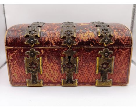 An early 20th century red leather jewellery box in the form of a casket, with gilt metal mounts, 16 cm wide