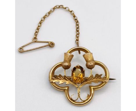 A 9ct gold and citrine brooch, decorated a thistle, 2.3 g (all in)