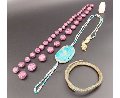 An Egyptian style carved wooden necklace, in the form of a scarab, a bronze bangle in the form of a snake, and assorted beads