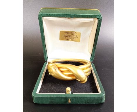 A gold plated metal double snake bangle,