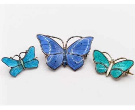 A silver and enamel butterfly brooch, 30 mm wide, and two others, 25 mm wide and 20 mm wide (3)