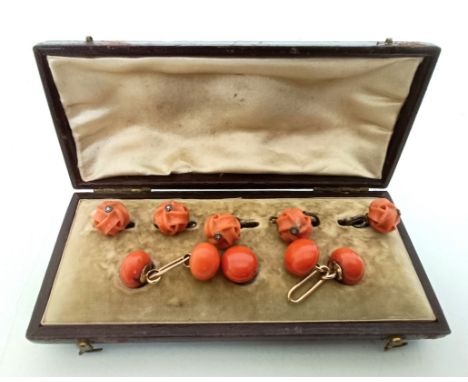 A pair of yellow metal and coral cufflinks, a matching button and four carved coral buttons, with a fitted box