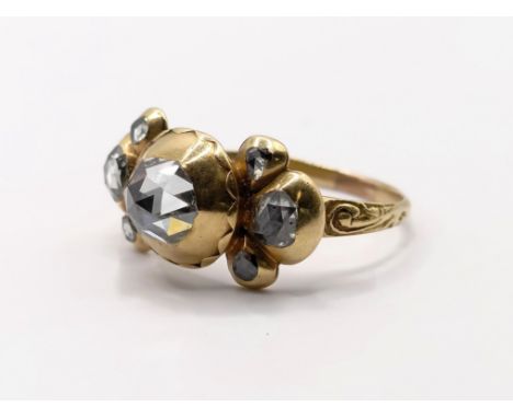 An antique yellow metal and diamond ring, with mixed cut diamonds, ring size M,