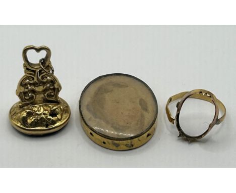 A 19th century yellow metal and red stone seal, carved a portrait, a ring lacking stone, and a gilt metal mounted oval pendan