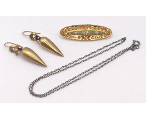 A 15ct gold and diamond oval brooch, 5.5 g (all in), a pair of yellow metal drop earrings, and a silver coloured metal chain 
