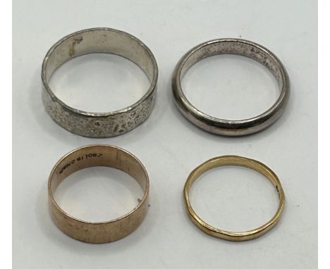 A 9ct gold wedding band, 1.3 g, a yellow metal ring, stamped solid gold and two silver coloured metal rings (4)