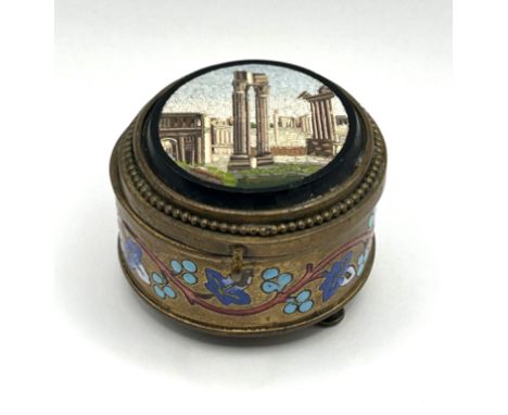 A gilt metal ring box, with a micro mosaic top, decorated a ruin, 5 cm diameter