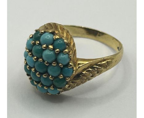 An 18ct gold and turquoise cluster ring, ring size MVariation of colour of turquoise, light surface wear, generally good orde