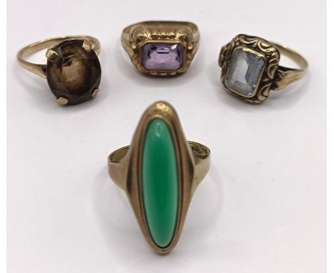 An early 20th century yellow metal and paste ring, and three other rings (4)