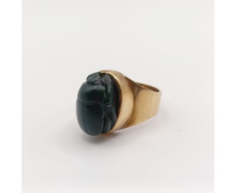 A 9ct gold and green stone ring, carved in the form of a scarab beetleRing size is SWeight 11.4 g all in.