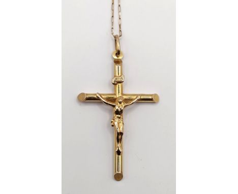 A 9ct gold crucifix, 2.9 g, and a 9ct gold chain