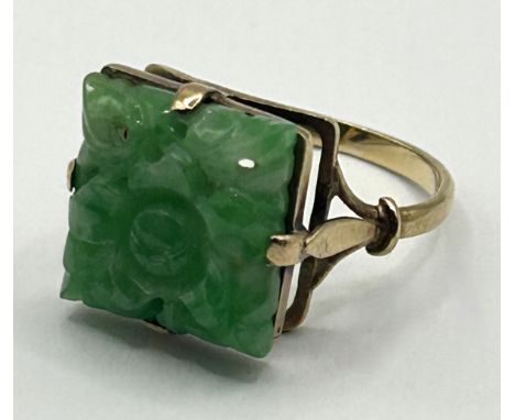 A 9ct gold and Chinese green stone ring, carved foliate forms