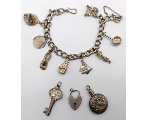 A silver charm bracelet, 47.6 g3 charms loose