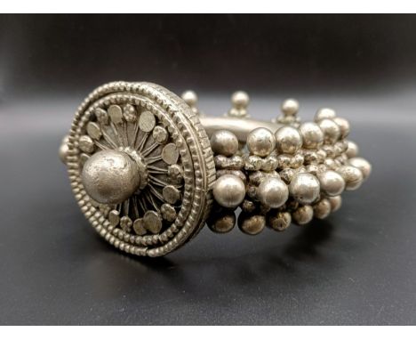 A large Eastern silver coloured metal bangle, 473 g