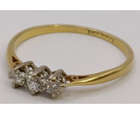 An 18ct gold and diamond three stone ring, ring size P
