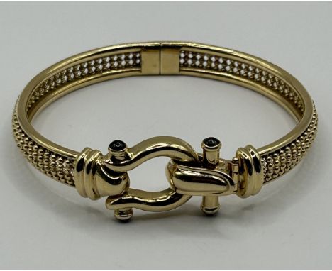 A 14ct gold Italian hinged bangle, 24.7 g (all in)Clasp functions well, clasp hinge has slight play as does the central hinge