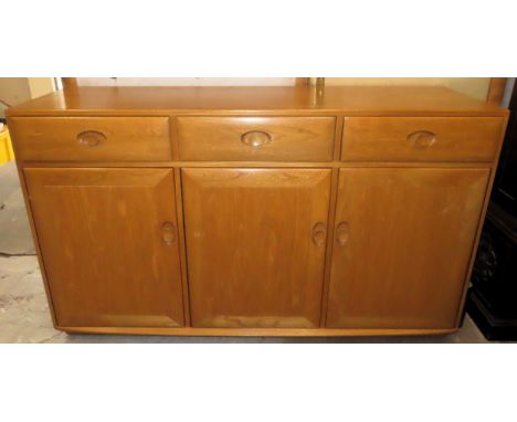 Ercol light oak coloured sideboard fitted with three drawers and three cupboard doors. Approx. 94 x 156 x 46cms