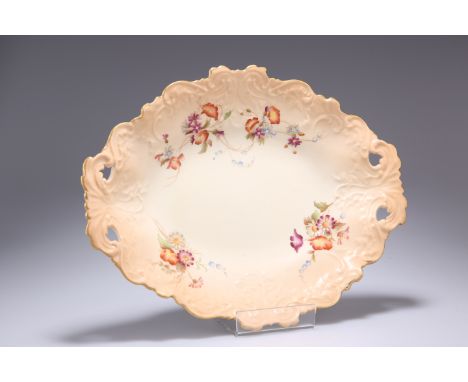 A ROYAL WORCESTER BLUSH IVORY BOWL, of shaped oval form with twin pierced handles, painted with four floral sprats against a 
