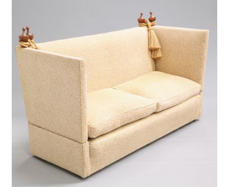 A KNOLE SOFA, with drop-ends and wooden urn finials. 190.5cm longThe absence of a Condition Report does not imply that a lot 