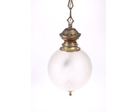 AN EARLY 20TH CENTURY BRASS AND FROSTED GLASS PENDANT CEILING LIGHT,&nbsp;the globular shade with oval and lozenge-shaped cut