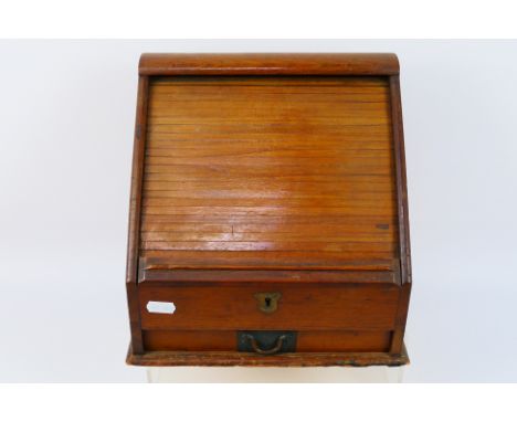 A vintage slope front desk organiser, tambour opening enclosing a fitted interior, above single drawer, approximately 26 cm x