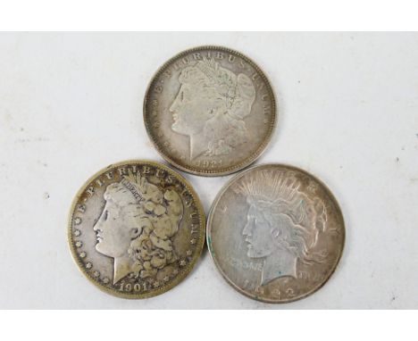 US Silver Coins - Three silver dollars comprising a 1901 Morgan (New Orleans), a 1921 Morgan (Philadelphia) and a 1922 Peace 